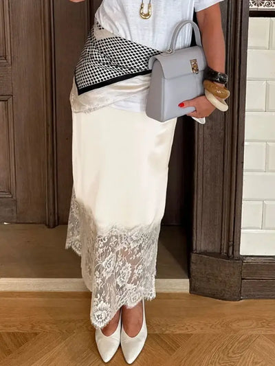 Ivory satin midi skirt with floral lace hem and side slit, styled with white pumps and gray bag