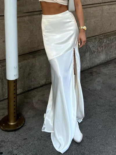 Close-up of white satin mermaid maxi skirt with side slit and floor-length flare