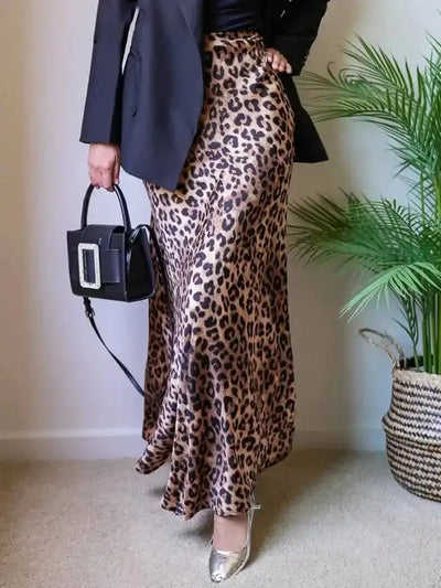Front view of leopard-print maxi satin skirt worn with black blazer and structured bag