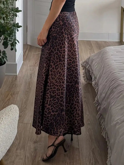 Side rear view of brown and black leopard-print maxi skirt with strappy heeled sandals
