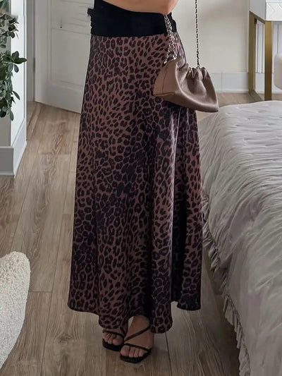 Front view of leopard-print maxi skirt with black tank top and chain crossbody bag