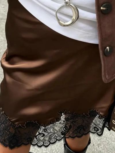 Brown satin mini skirt with black lace hem detail, worn with white top, suede jacket and knee-high boots