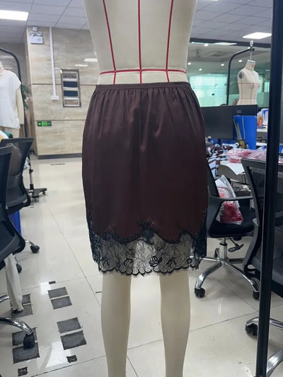 Side view of dark brown lace-hem mini skirt on dress form showing length and lace trim proportion