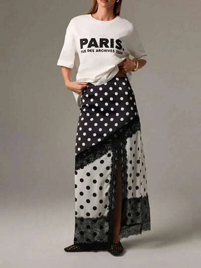 Full-length front view of model wearing polka dot satin maxi skirt with Paris graphic white tee