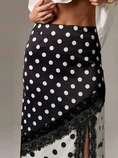 Close-up of black polka dot satin skirt waistband with lace trim and diagonal lace detail
