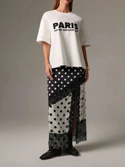 Full-length side view showing sheer lower panel of polka dot maxi skirt with black lace border