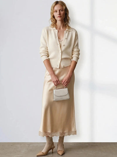 Champagne satin midi skirt with lace trim, styled under a cream knit cardigan with heeled slingback shoes