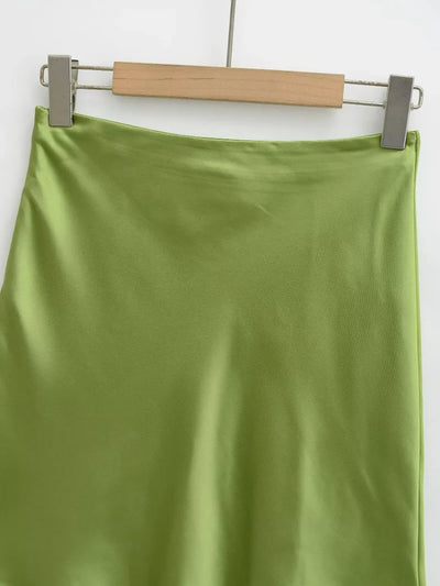 Olive green satin mini skirt on hanger, close-up of waistband and fabric sheen
