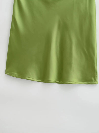 Lower half of olive green satin mini skirt showing curved hem detail on white background