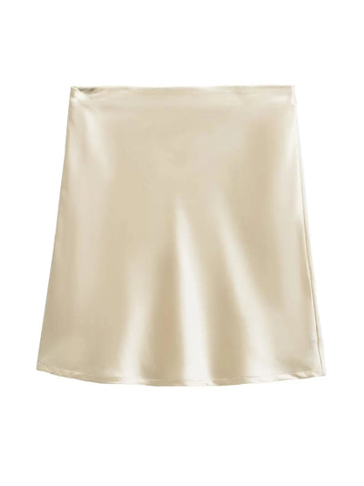 Flat lay of champagne satin mini skirt showing full A-line silhouette on white background