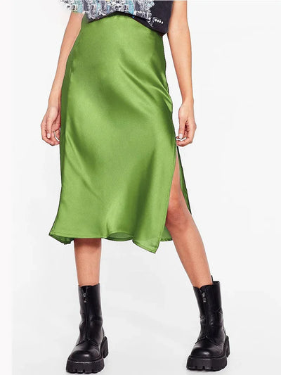 Front view of olive green satin midi skirt with side slit worn with black boots