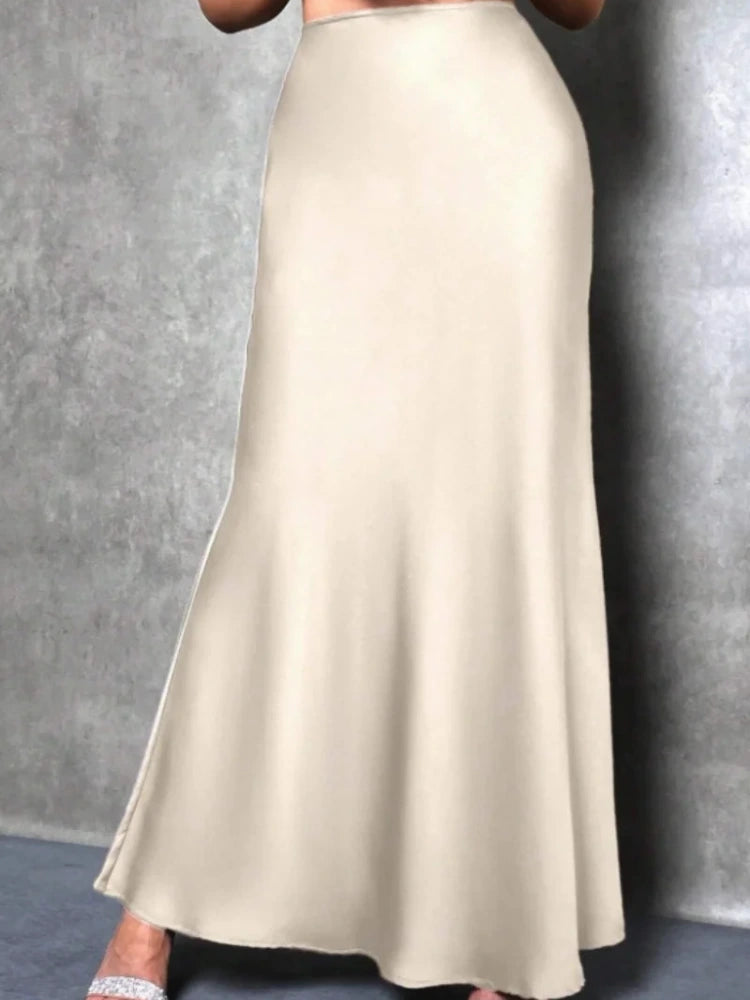 Apricot high-waist flared satin midi skirt shown from the side on a model