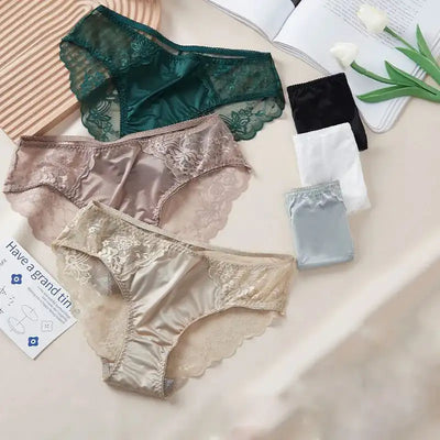 Multiple lace satin panties in emerald, beige, black, white, and gray flat lay