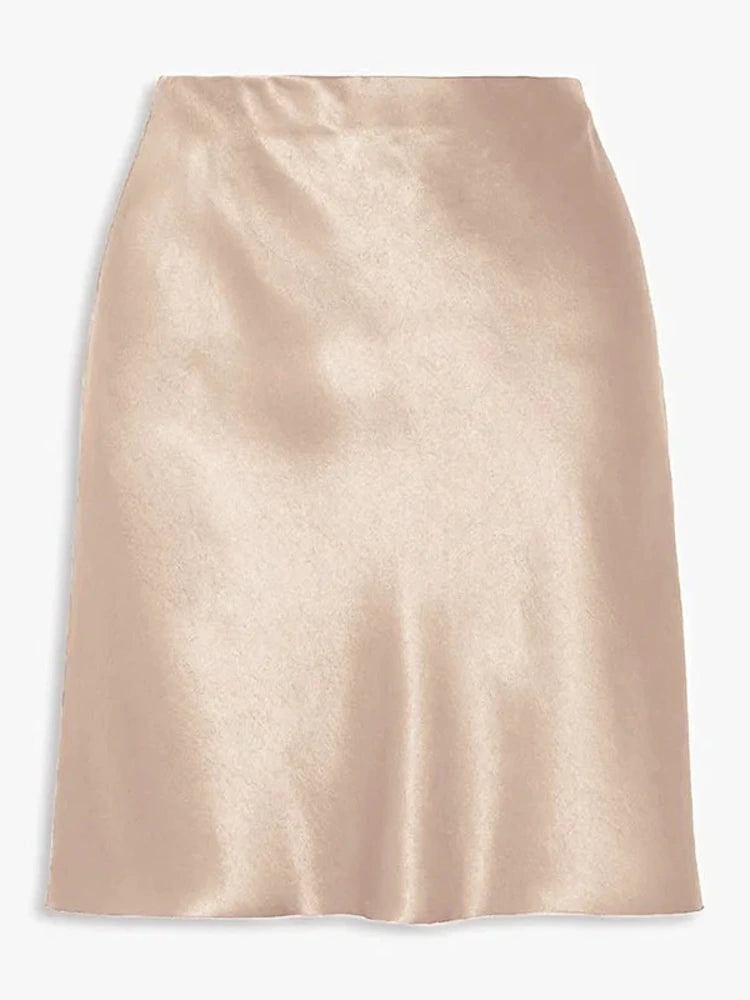 Champagne high-waist satin mini skirt styled with a cropped cream knit cardigan, front view on model