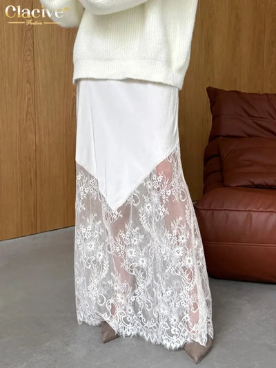 Side view of white satin maxi skirt showing diagonal lace splice and scalloped hem