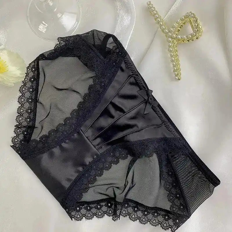 Black satin panties with scalloped lace trim and sheer mesh side panels flat lay