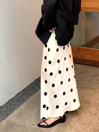 Side view of ivory black polka dot floor-length satin skirt styled with an oversized black blazer