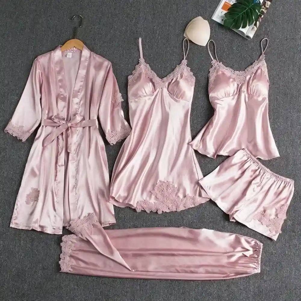 Pink satin five-piece pajama set with lace trim robe nightdress cami shorts and pants flat lay