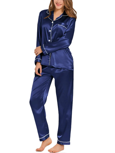 Woman wearing navy satin long sleeve button-down pajama set with white contrast piping