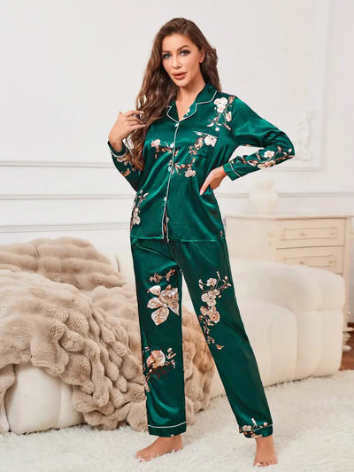 Woman standing posing in green floral crane satin long-sleeve pajama set with notched lapel collar