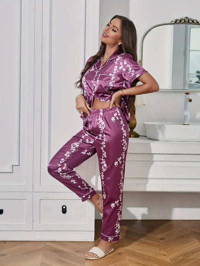Side view of deep purple cherry blossom satin pajama set with cropped top tied at waist and long pants