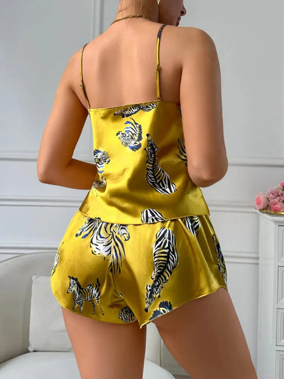 Back view of golden yellow zebra print satin pajama set showing adjustable straps and shorts