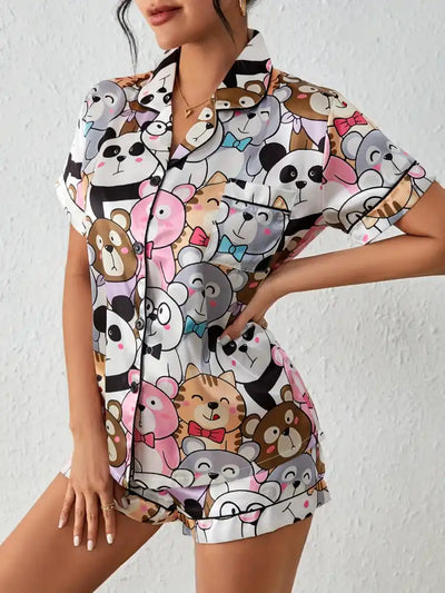 Front view of cartoon animal print satin pajama set with button-down top and shorts