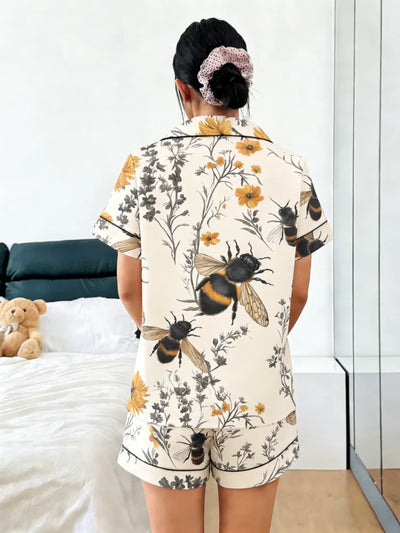 Back view of ivory bumblebee and floral print satin pajama set with black piping