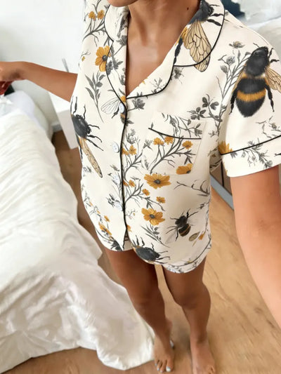 Front view of bumblebee wildflower print satin button-front pajama top and shorts