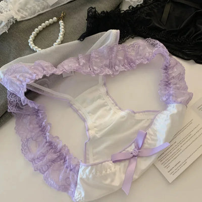White satin panties with lavender lace ruffles and lilac bow, interior view flat lay