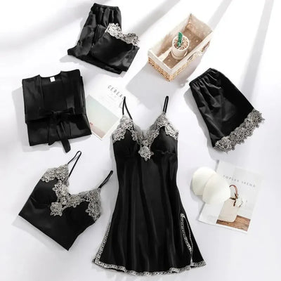 Black satin five-piece pajama set with gray scalloped lace trim flat lay