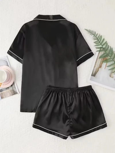 Back flat lay of black satin pajama shirt and shorts showing clean reverse finish