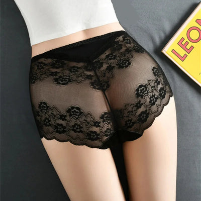 Rear view of black sheer floral lace panties showing scalloped hem on a model