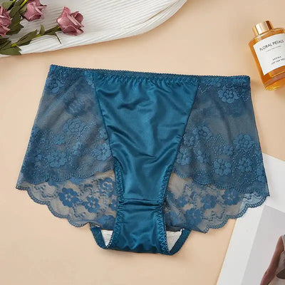 Flat lay of teal satin panties with sheer floral lace sides and scalloped leg hem