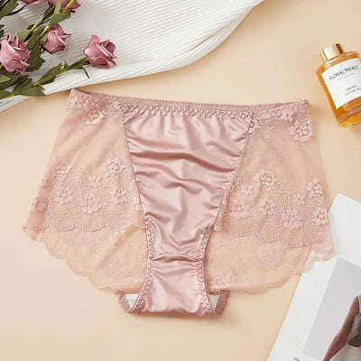 Flat lay of pink satin panties with floral lace side panels and scalloped leg opening