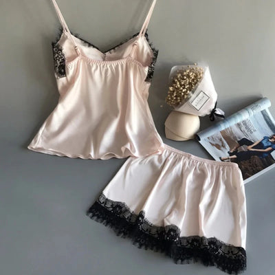 Blush satin lace-trim cami and shorts pajama set styled with dried flowers and magazine