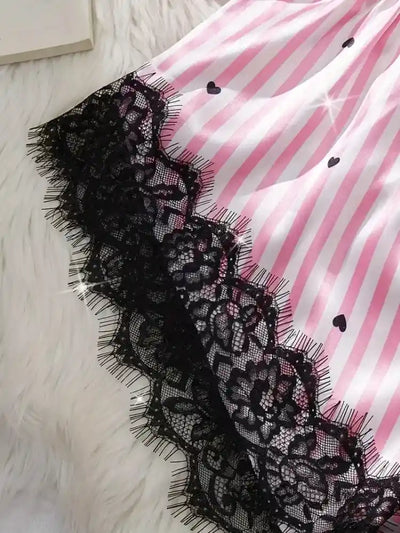 Close-up of scalloped black lace hem on pink striped satin pajama shorts