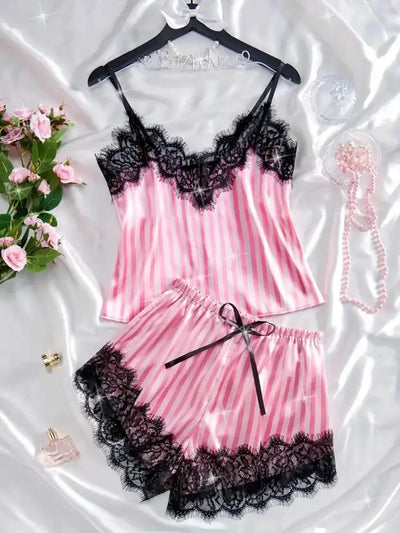 Pink striped satin cami and shorts PJ set with black lace hem, styled with roses and pearls