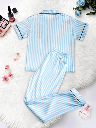 Sky blue striped satin pajama set flat lay, back view showing contrast piping on shirt and full-length pants