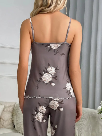 Back view of a woman in a gray peony print satin cami top with adjustable spaghetti straps