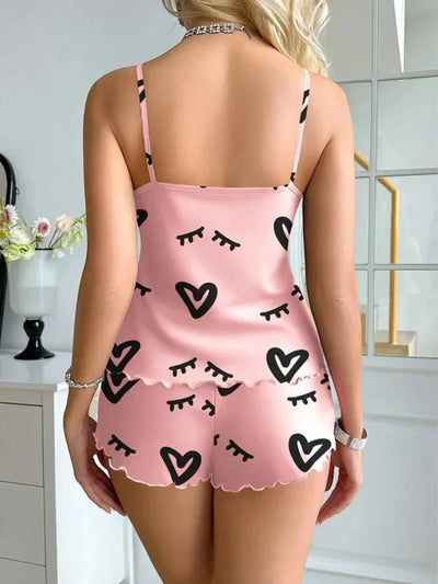 Back view of pink satin pajama set showing ruffle-edged shorts and cami straps