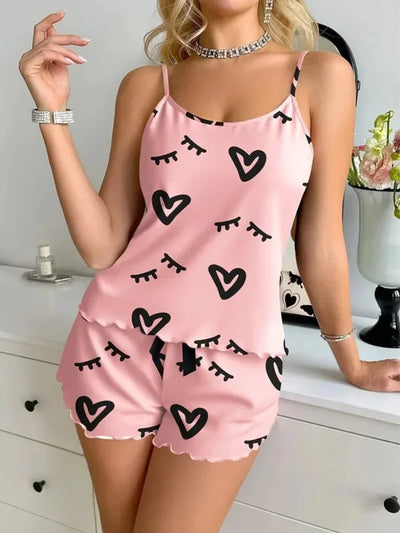 Full front view of pink satin pajama set with ruffle shorts and heart print