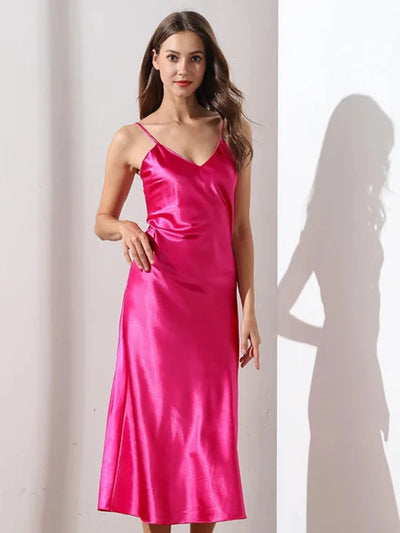 Woman wearing hot pink satin midi nightgown with V-neckline and adjustable straps, front view