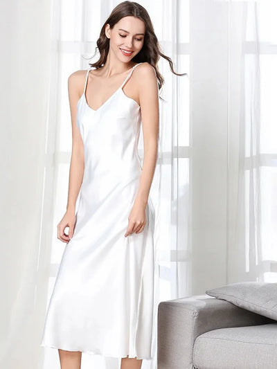 Woman wearing white satin midi nightgown with V-neckline and thin spaghetti straps, front view