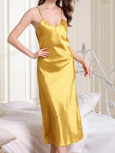 Woman wearing mustard yellow satin midi nightgown with V-neckline and spaghetti straps, front view