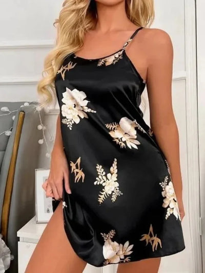 Full-length view of a black floral satin nightgown on a standing model, thin straps, mid-thigh length