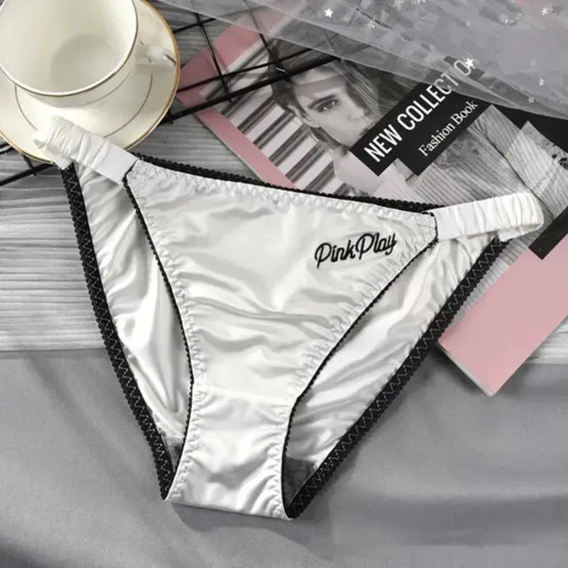 Silver high-shine low-rise bikini panties with black picot trim and embroidered Pink Play script at hip