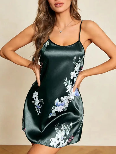 Woman wearing dark green floral satin mini nightgown with adjustable spaghetti straps, hands on hips