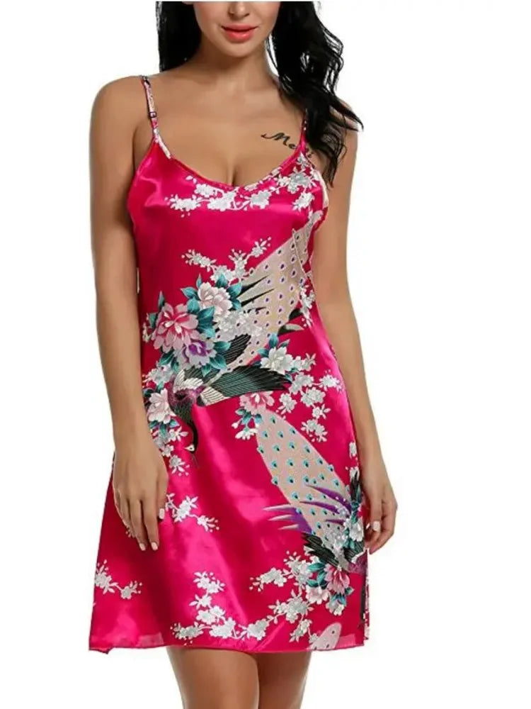 Woman wearing a hot pink satin mini nightgown with peacock and floral print, adjustable spaghetti straps, V-neckline