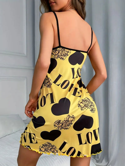 Back view of yellow satin nightgown showing open back, spaghetti straps, and all-over love print